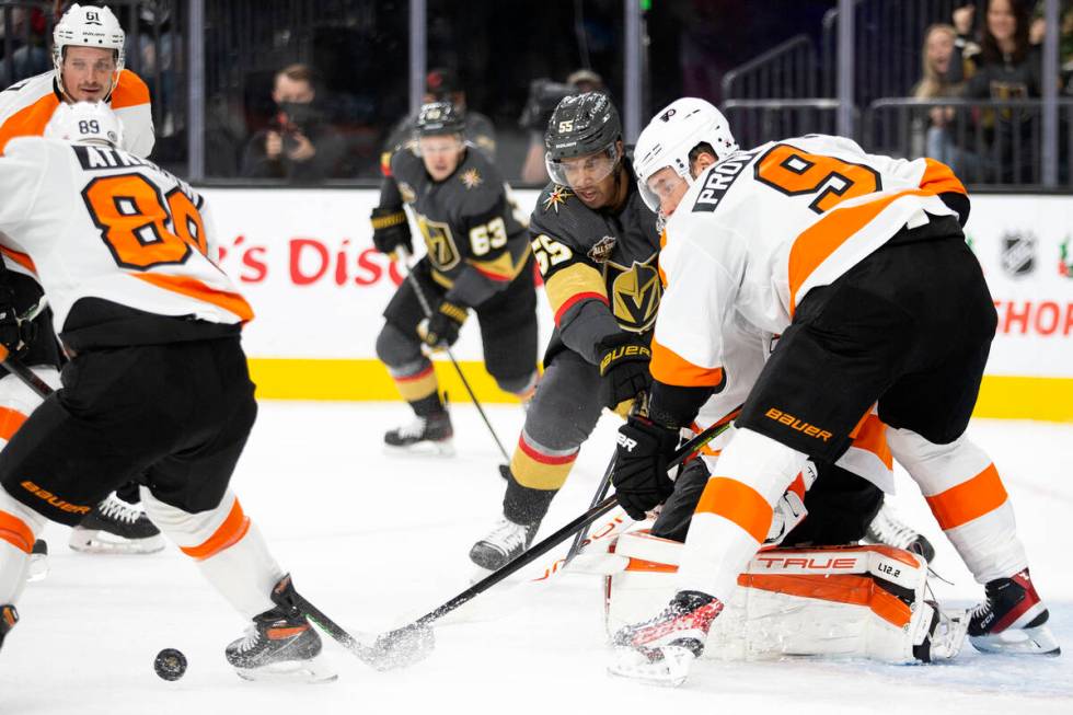 Golden Knights right wing Keegan Kolesar (55) fights for the puc while Flyers right wing Cam At ...