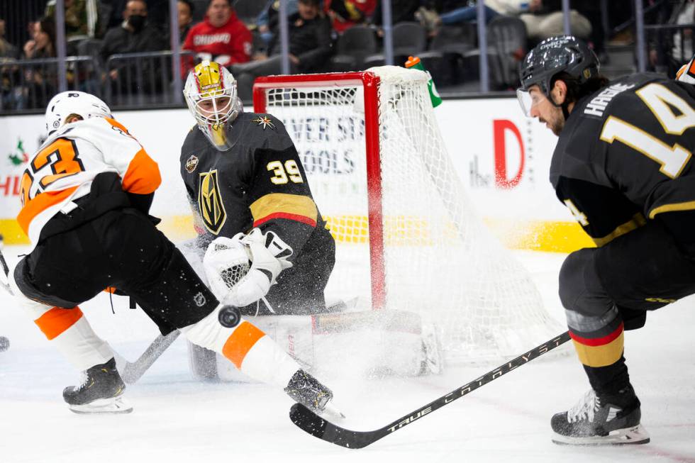 Golden Knights goaltender Laurent Brossoit (39) deflects a goal shot by Flyers left wing Oskar ...