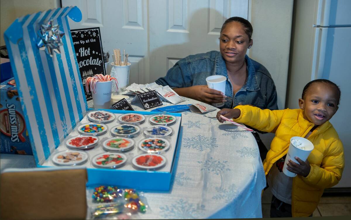 Dshyra Hobbs makes her son Aayden Hobbs, 3, a heart transplant recipient, some hot chocolate af ...