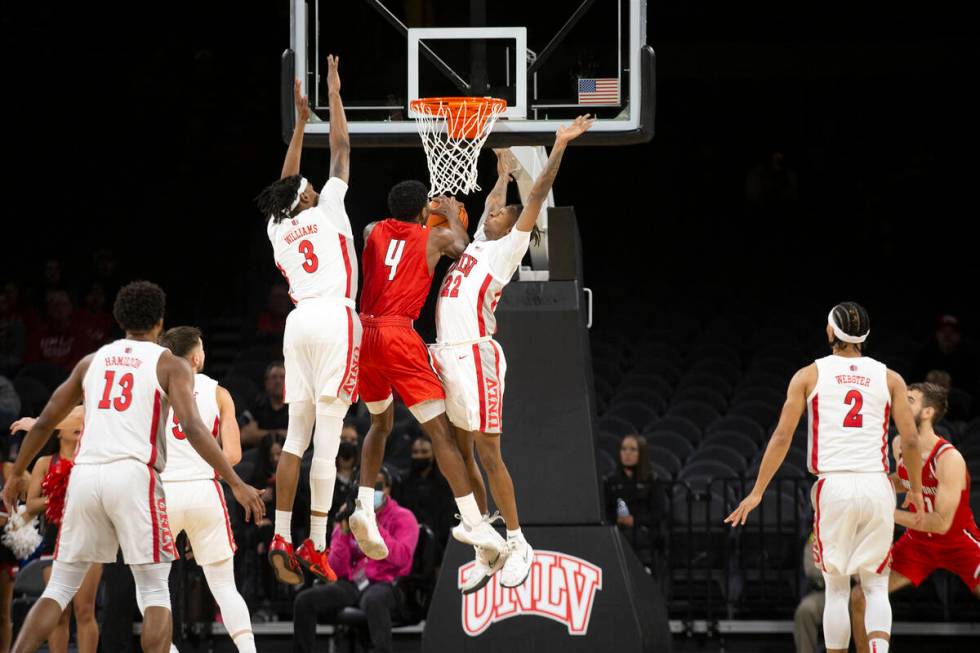 UNLV Rebels guard Josh Baker (22) and forward Donovan Williams (3) jump to block a shot by Hart ...