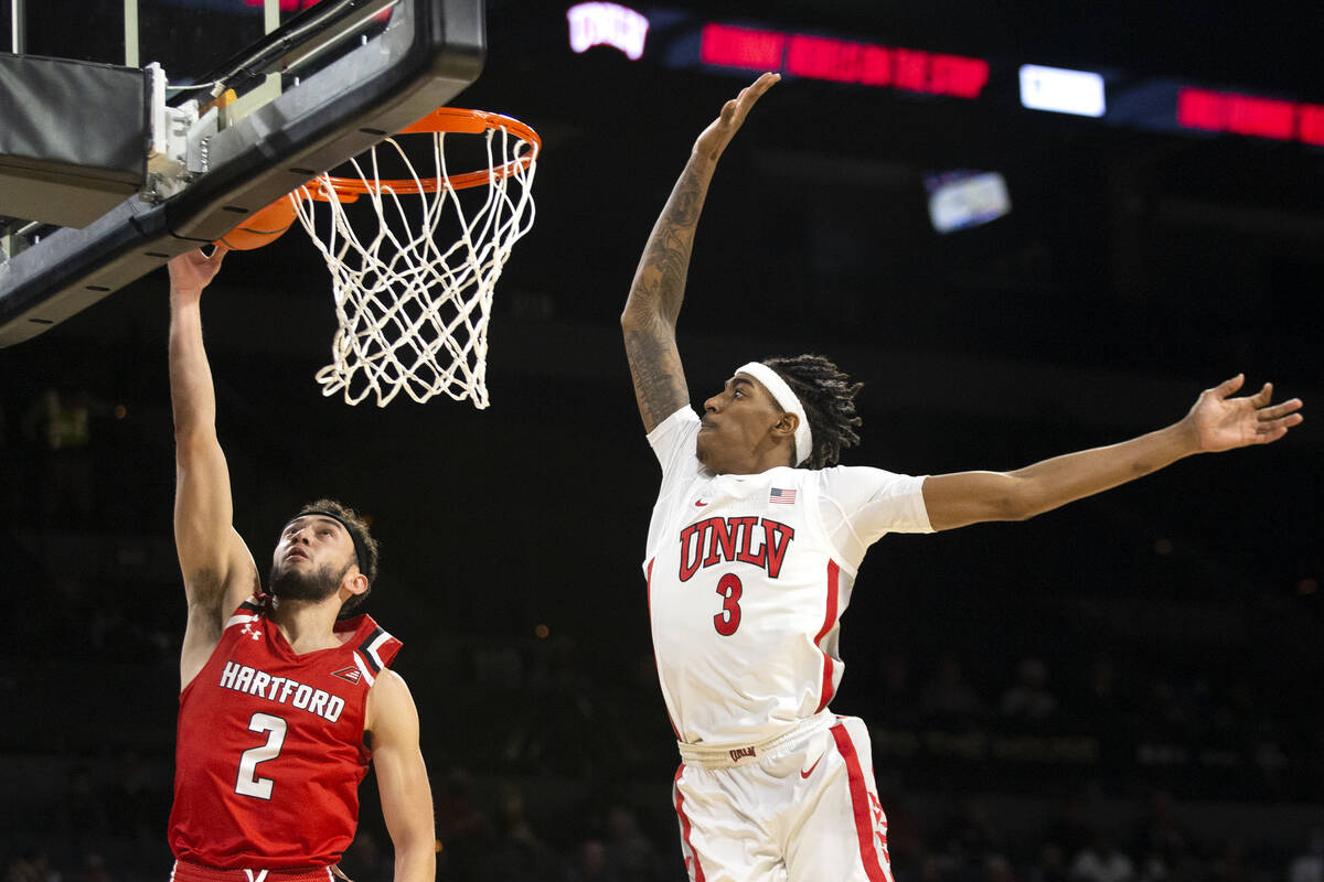 UNLV Rebels forward Donovan Williams (3) jumps to block a shot by Hartford Hawks guard D.J. Mit ...