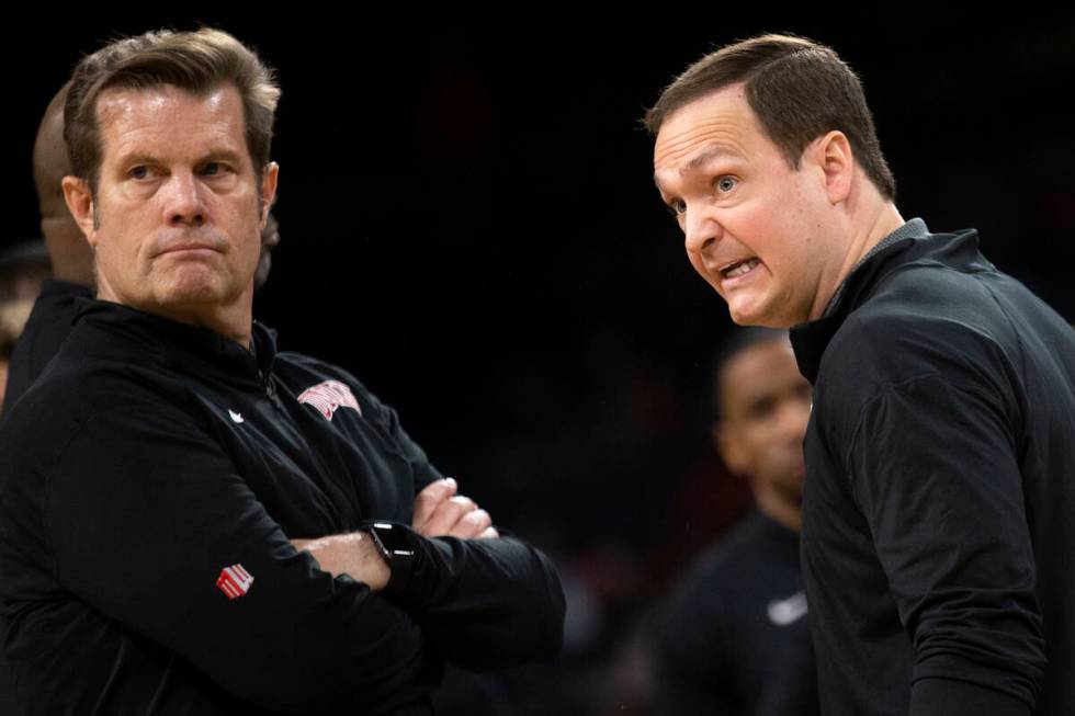 UNLV Rebels assistant coach Tim Buckley, left, and head coach Kevin Kruger speak to a referee i ...