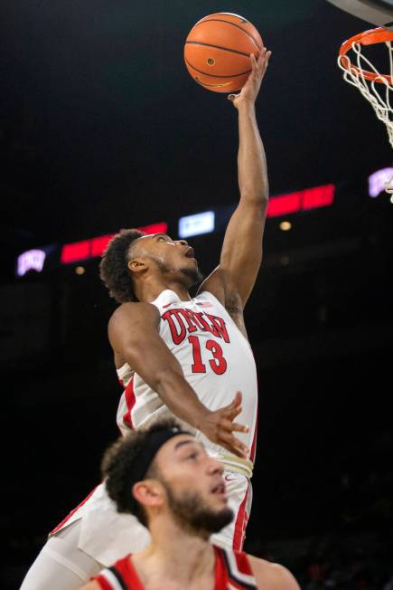 UNLV Rebels guard Bryce Hamilton (13) shoots against Hartford Hawks guard D.J. Mitchell (2) dur ...