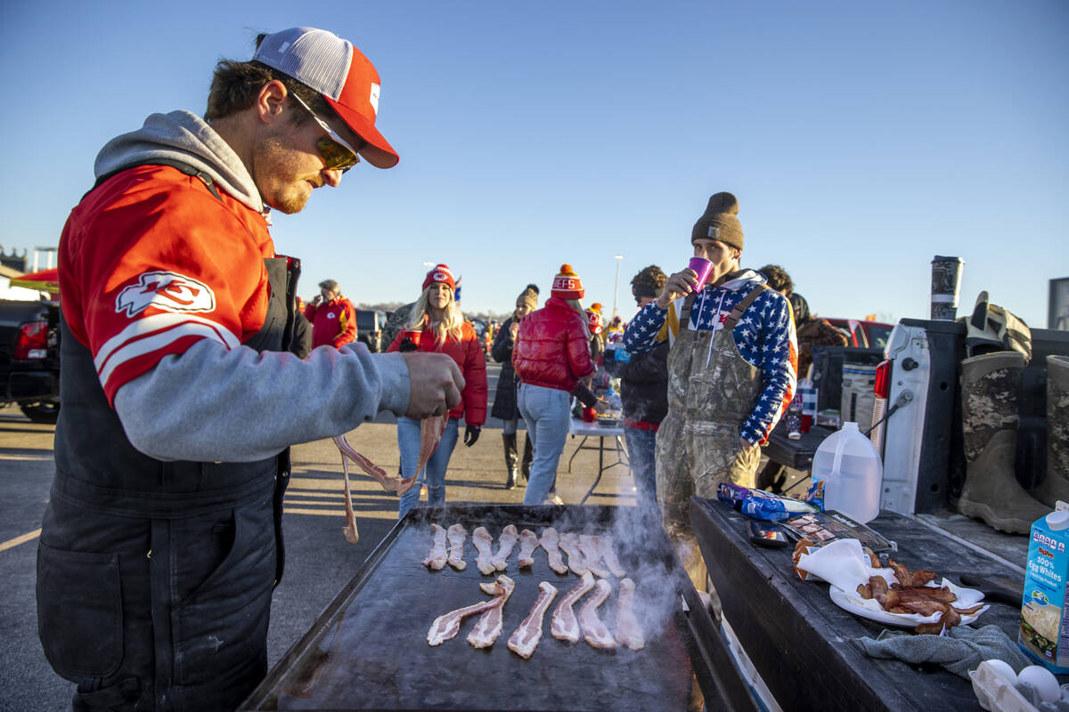 Fans cook breakfast and begin to socialize in the red lot tailgate before the Raiders face the ...
