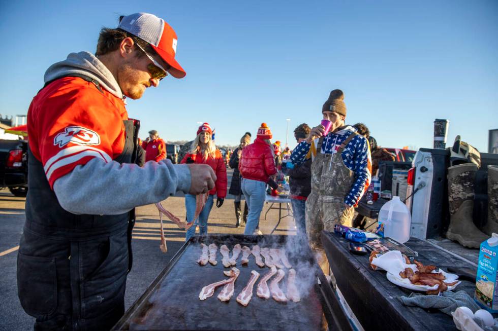 Fans cook breakfast and begin to socialize in the red lot tailgate before the Raiders face the ...