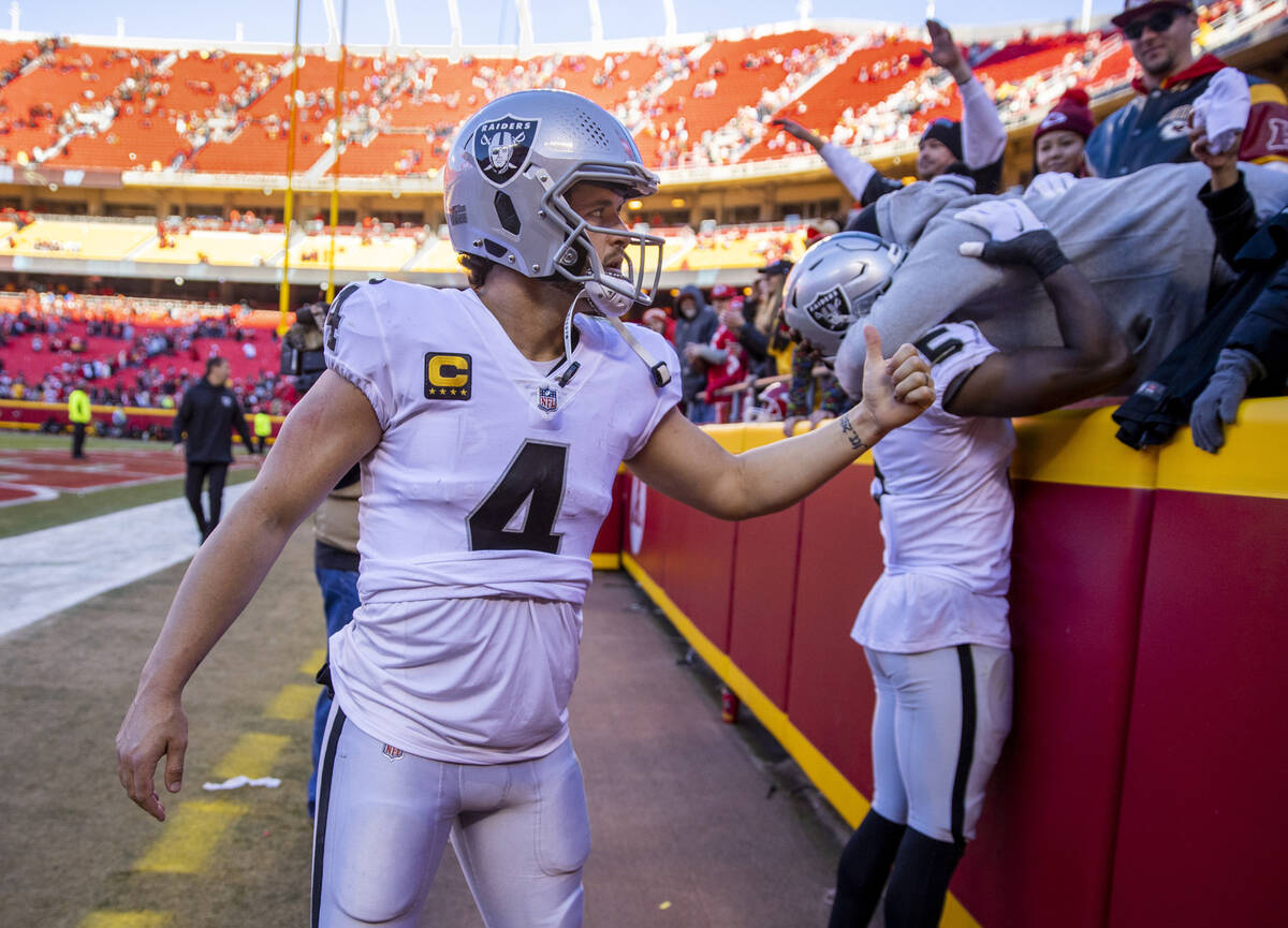 Raiders quarterback Derek Carr (4) gives a thumbs up to a Kansas City Chiefs fan after giving t ...
