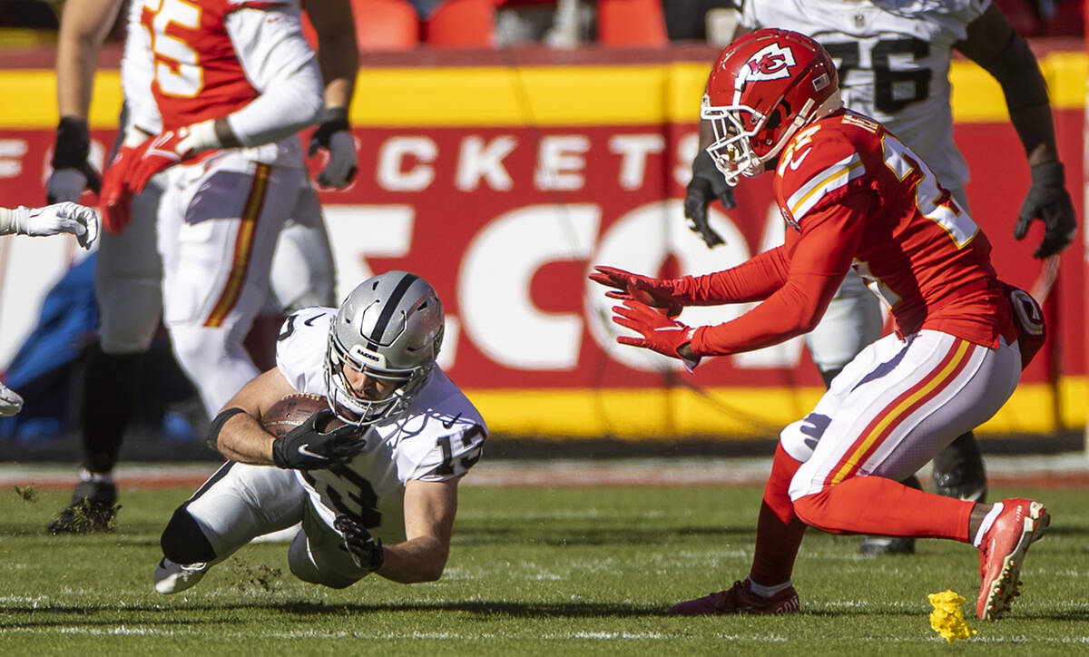 Raiders wide receiver Hunter Renfrow (13) dives for a few more yards as Kansas City Chiefs corn ...