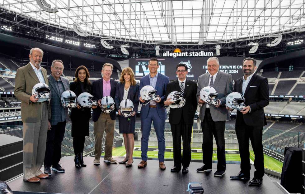 VIP guests hold ceremonial helmets on stage following a press conference event announcing the N ...