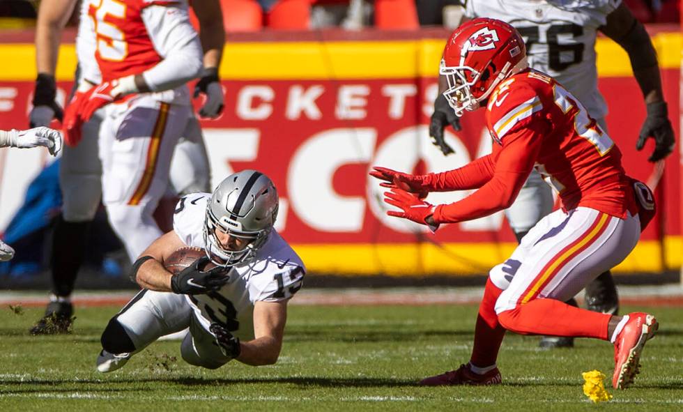 Raiders wide receiver Hunter Renfrow (13) dives for a few more yards as Kansas City Chiefs corn ...