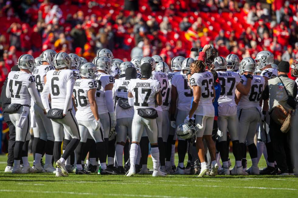 The Raiders huddle over the Kansas City Chiefs logo before an NFL football game on Sunday, Dec. ...