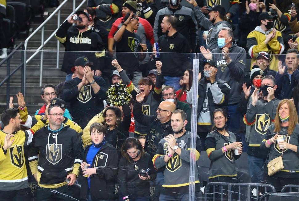 Golden Knights fans celebrate after a goal by defenseman Zach Whitecloud, not pictured, during ...