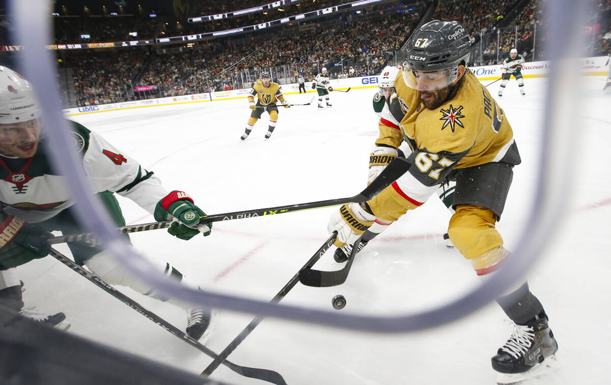 Minnesota Wild defenseman Jon Merrill (4) and Golden Knights left wing Max Pacioretty (67) batt ...