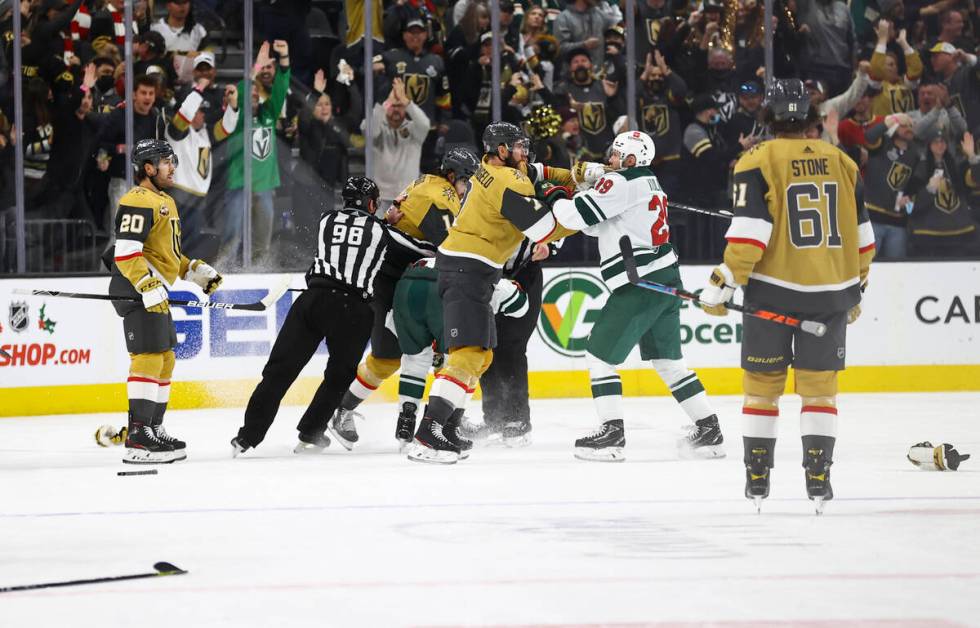 Members of the Golden Knights and Minnesota Wild fight during the second period of an NHL hocke ...