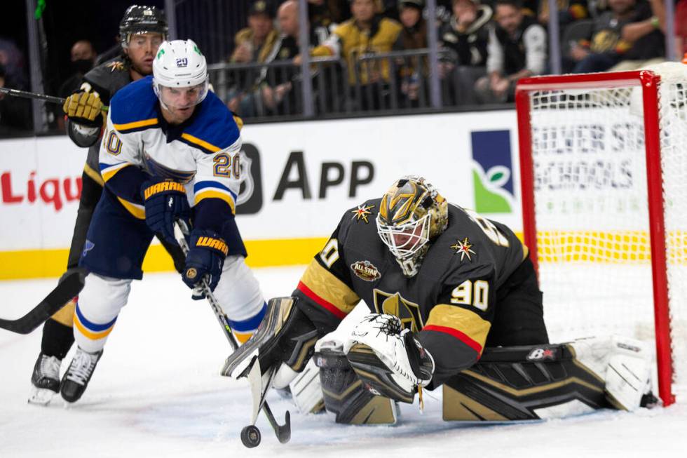 Golden Knights goaltender Robin Lehner (90) deflects a shot on goal while Blues left wing Brand ...