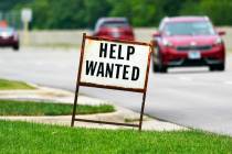 A help-wanted sign is displayed at a gas station in Mount Prospect, Ill., in July 2021. (AP Pho ...