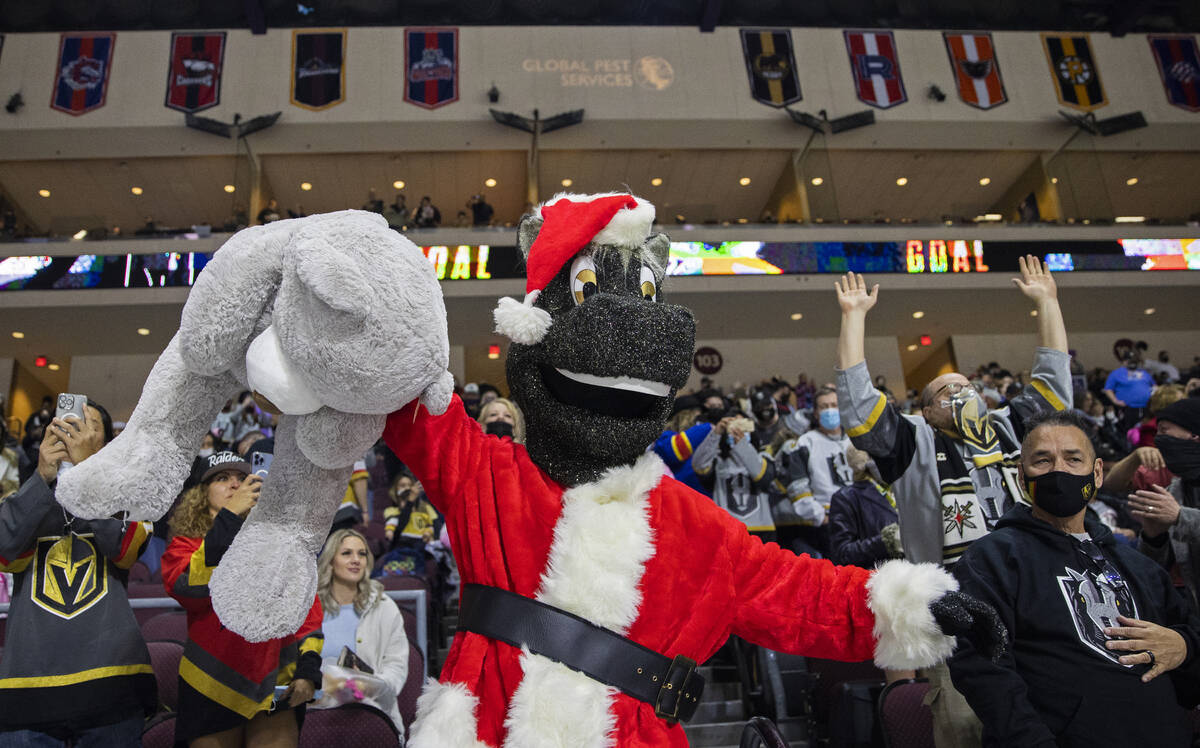 Silver Knights mascot “Lucky” throws a teddy bear on the ice after the first Hend ...