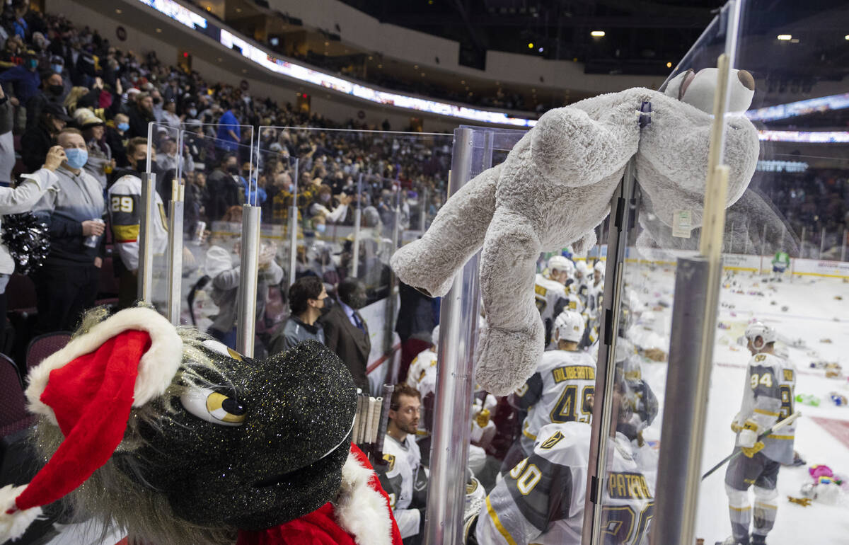 Silver Knights mascot “Lucky” throws a teddy bear on the ice after the first Hen ...