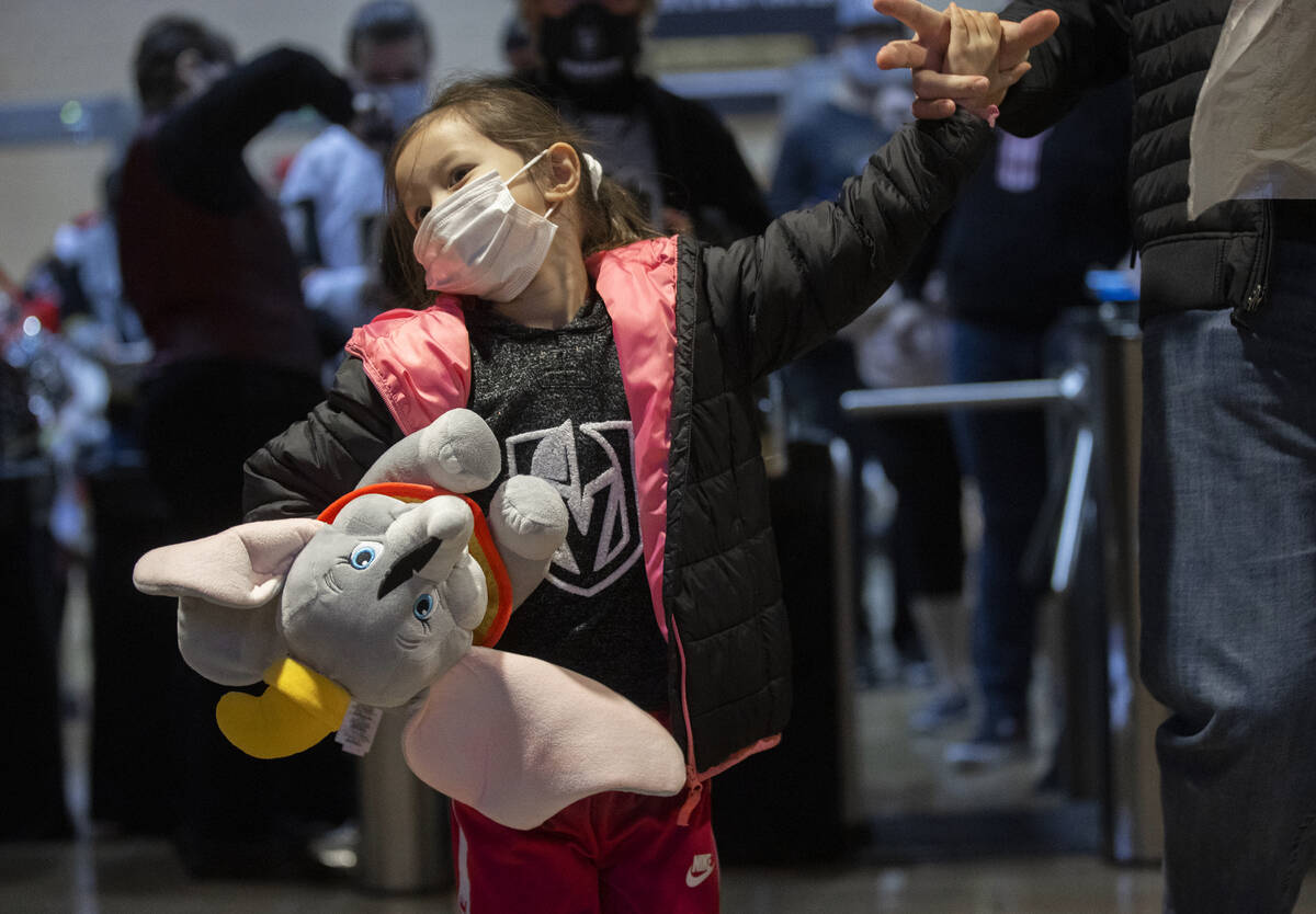 Amelia Simonis, 4, brings a toy elephant to throw on the ice after the first Silver Knights goa ...