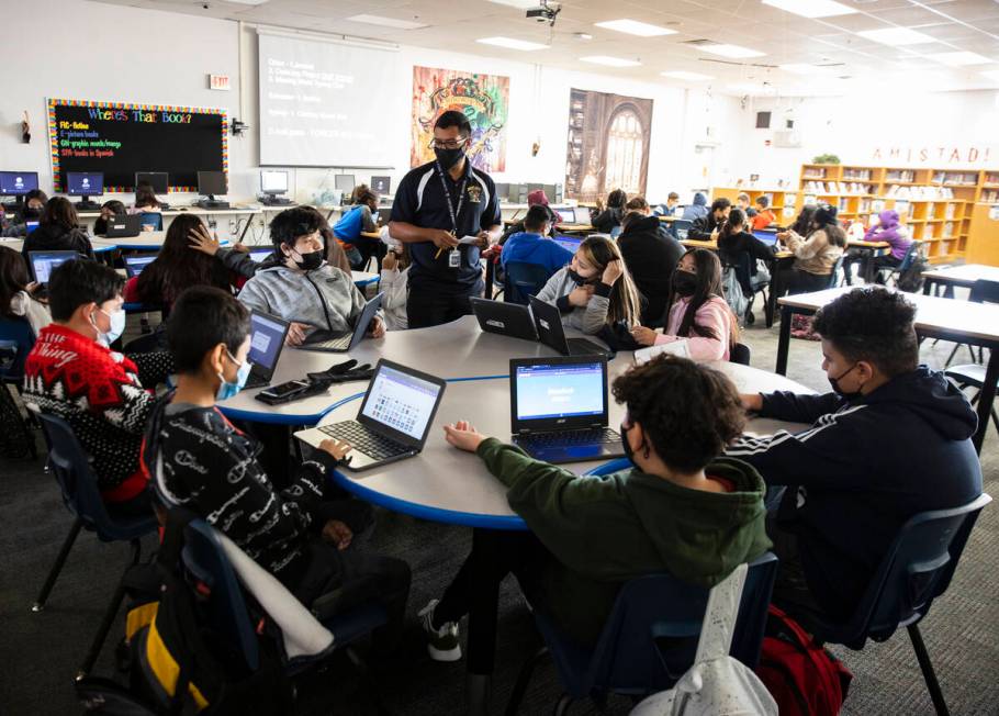 Cristian Calata, center, a substitute teacher at Bailey Middle School, works with three classes ...