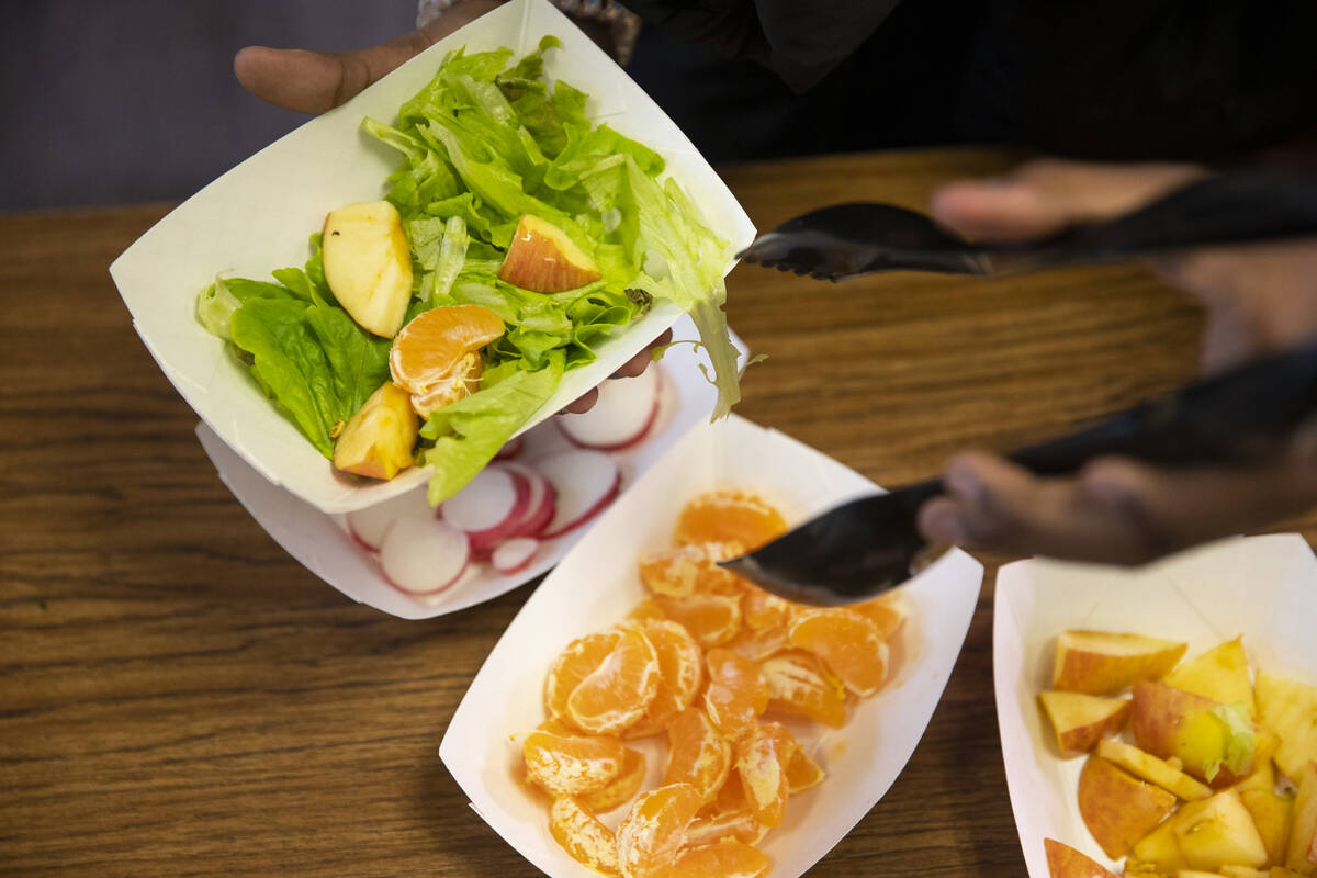 Kha'Laela Robinson, 10, makes a salad during a Gardening Club meeting at Dearing Elementary Sch ...