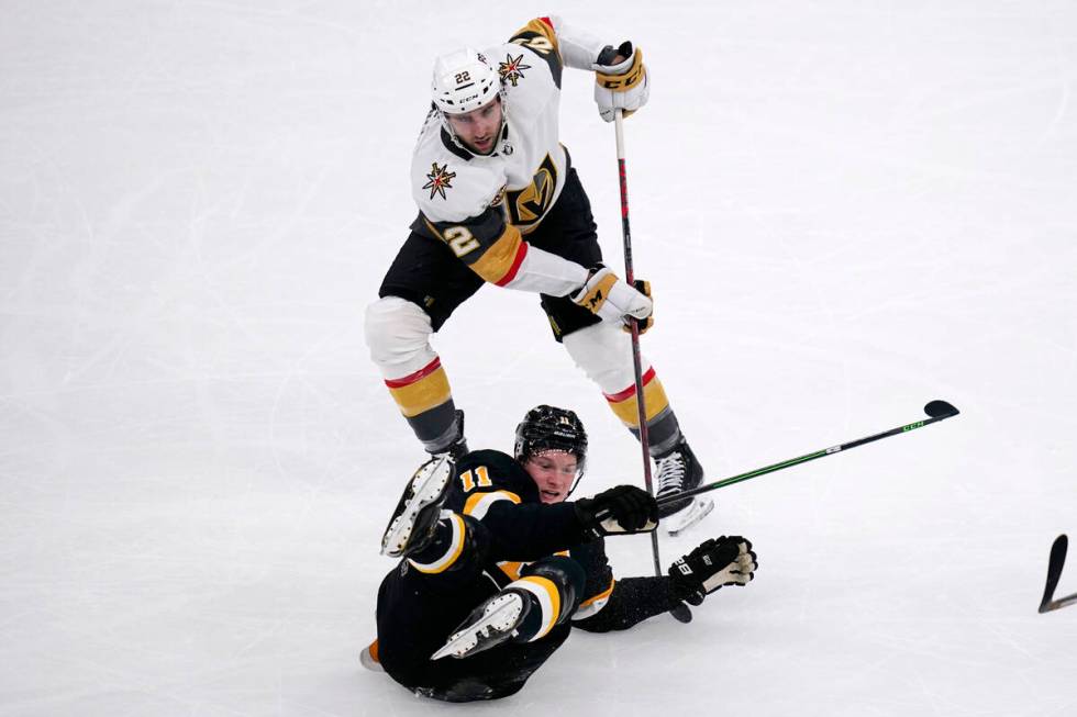 Boston Bruins center Trent Frederic (11) drops to the ice while battling Vegas Golden Knights c ...