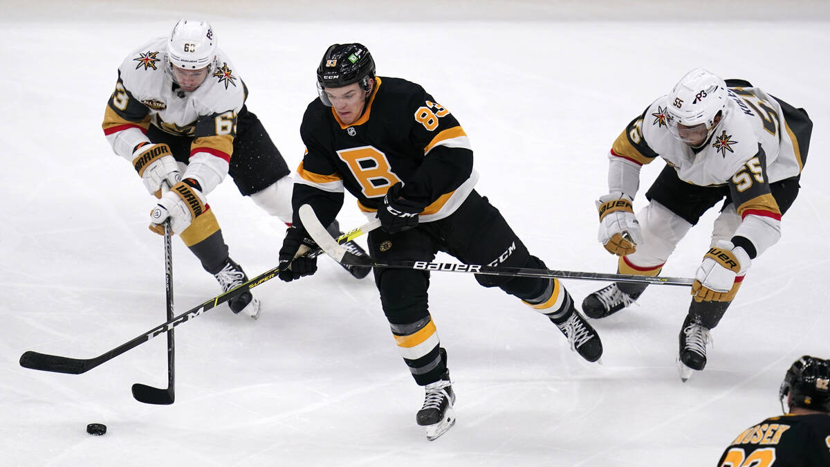 Boston Bruins center Karson Kuhlman (83) loses the puck while pressured by Vegas Golden Knights ...