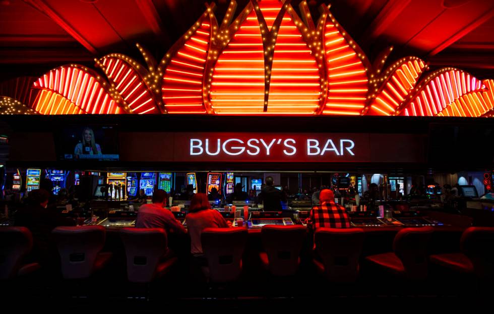 People drink and play tabletop gaming machines at BugsyÕs Bar in the Flamingo in Las Vegas ...