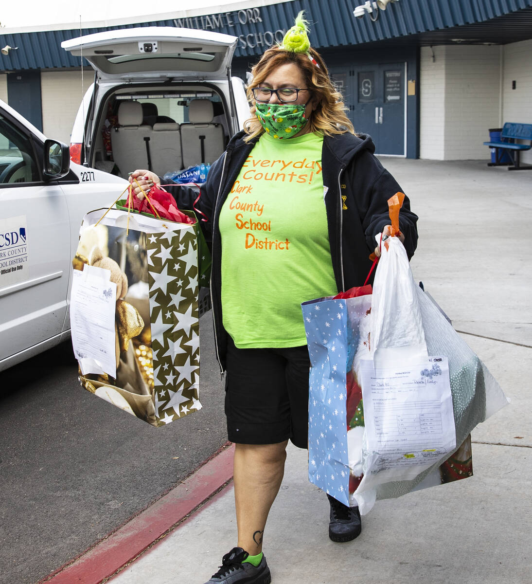 Cassandria Redwine, the Clark County attendance officer, carries gift bags to load into her v ...