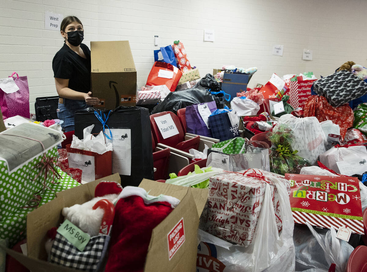 Talia Rothman, a volunteer, sorts out gift bags that will be delivered to students in need on T ...