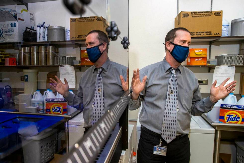 Dr. Mark Pandori, Director of the Nevada State Public Health Lab, with one of their automated g ...