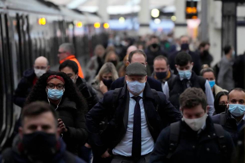 People disembark from a train during the morning rush-hour at Waterloo railway station in Londo ...