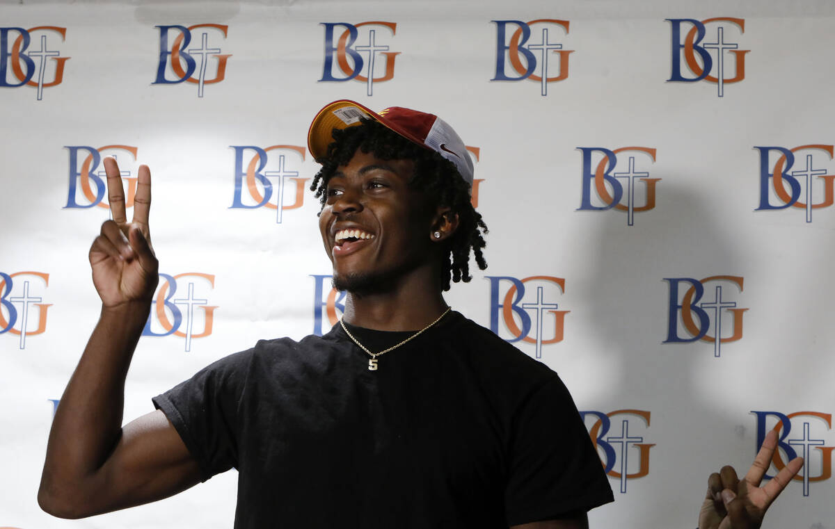 Bishop Gorman High School football player Zion Branch shows a v-sign after he decided to go to ...