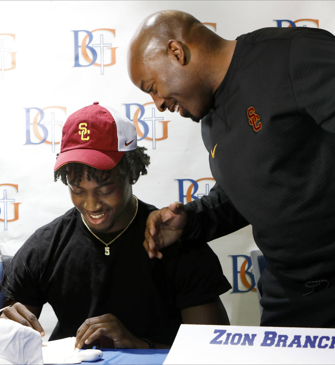 Bishop Gorman High School football player Zion Branch, left, prepares to sign with University o ...