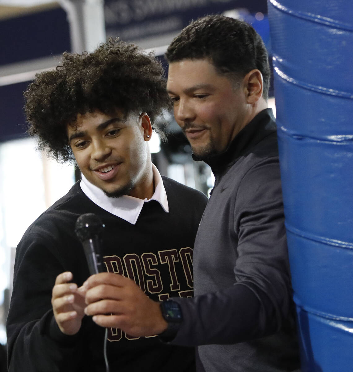 Bishop Gorman High School football player Cam'ron Barfield, left, receives a microphone from he ...
