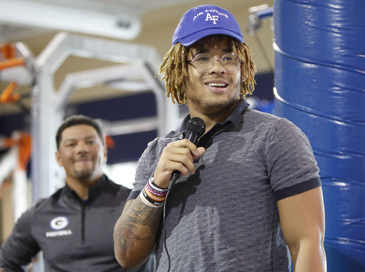 Bishop Gorman High School football player Jeremiah-Joseph 'JJ' Bwire, right, speaks before sign ...