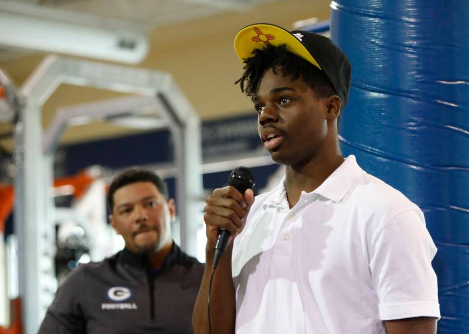 Bishop Gorman High School football player Jonathan Brady, right, speaks before signing with N ...