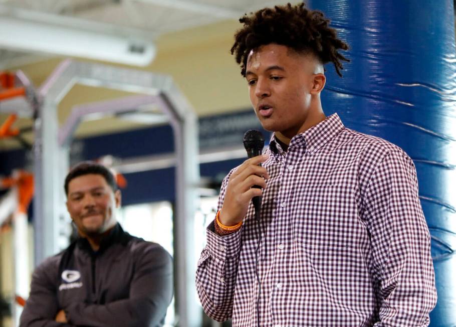 Bishop Gorman High School football player Benjamin Hudson, right, speaks before signing with St ...