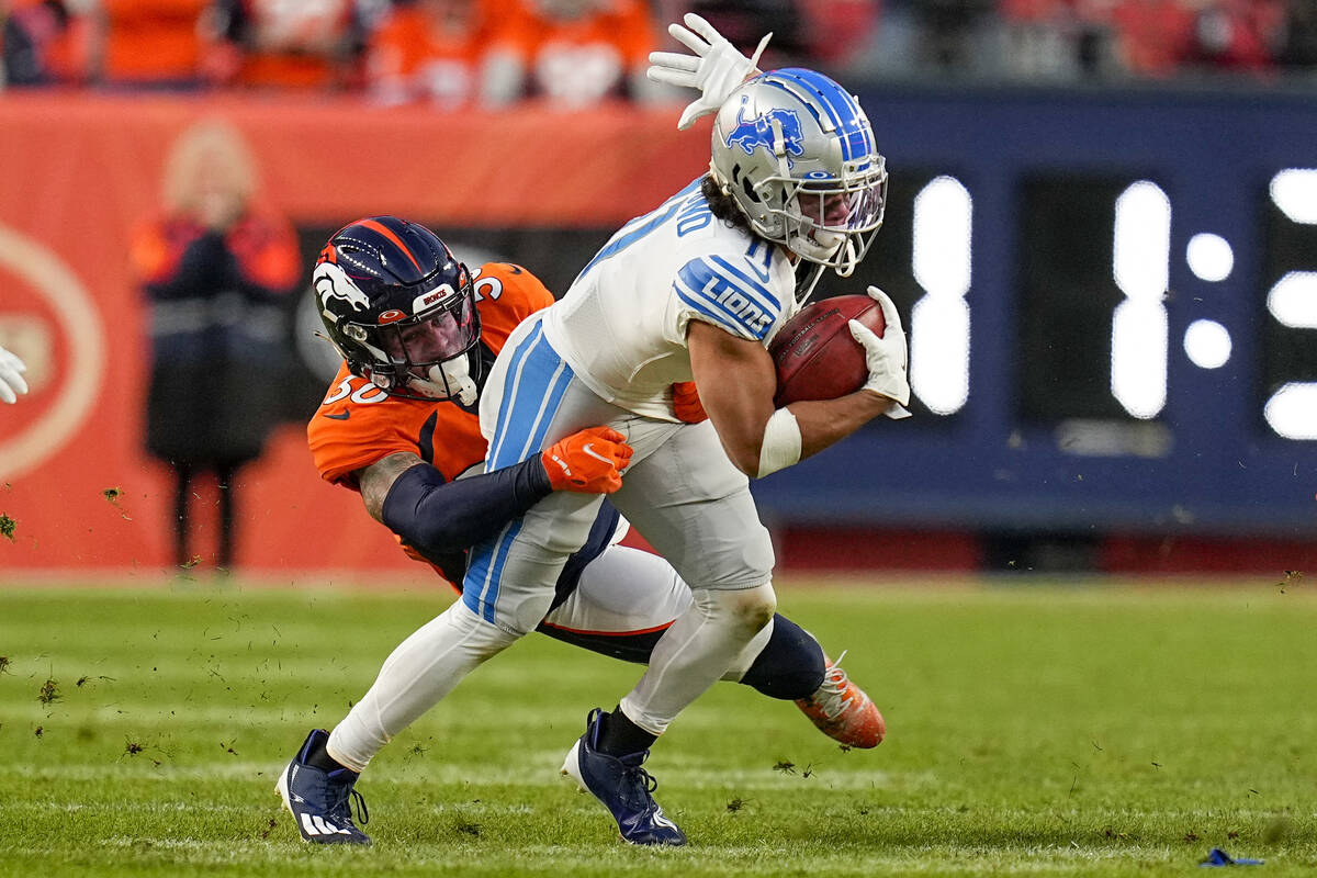 Detroit Lions wide receiver Kalif Raymond (11) is tackled by Denver Broncos safety Caden Sterns ...