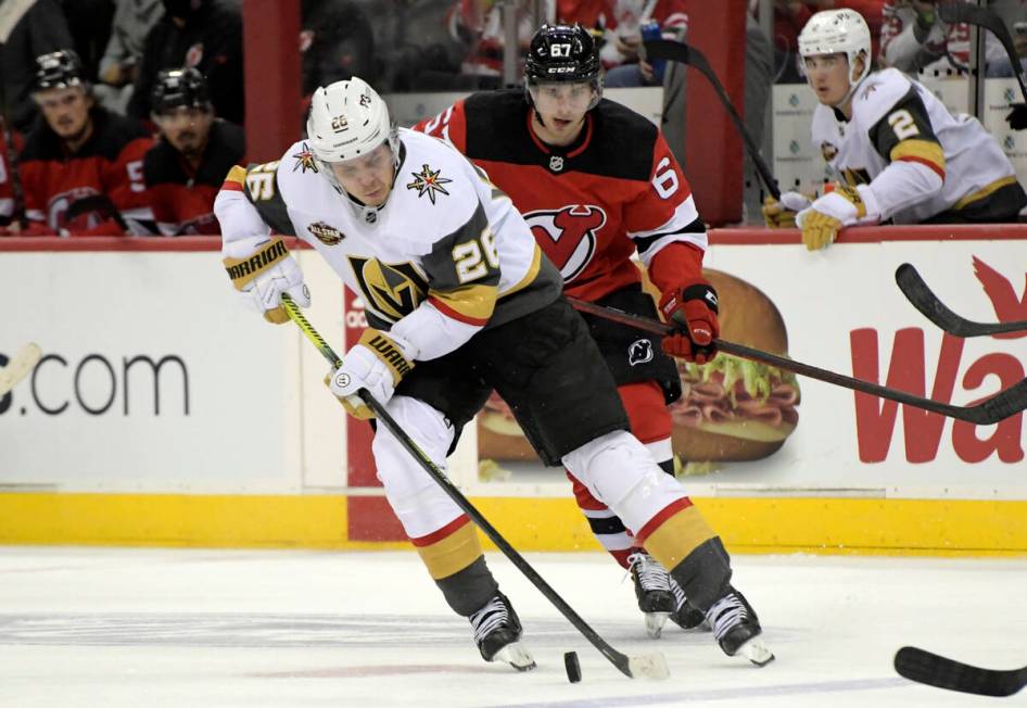 Vegas Golden Knights center Mattias Janmark (26) skates with the puck ahead of New Jersey Devil ...