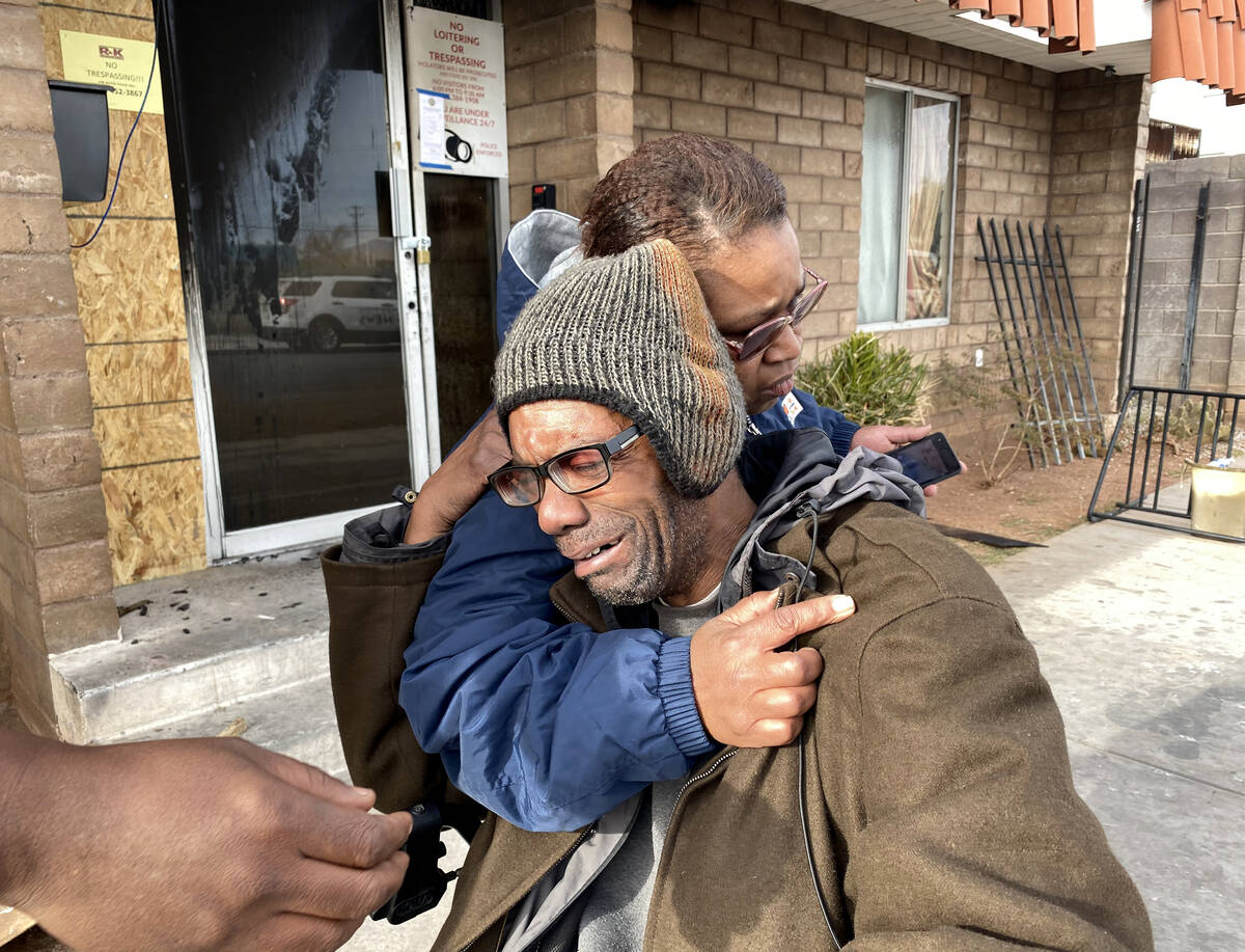 Victor Cotton gets a hug from fellow resident Tia Dotson at Alpine Motel Apartments after a fir ...