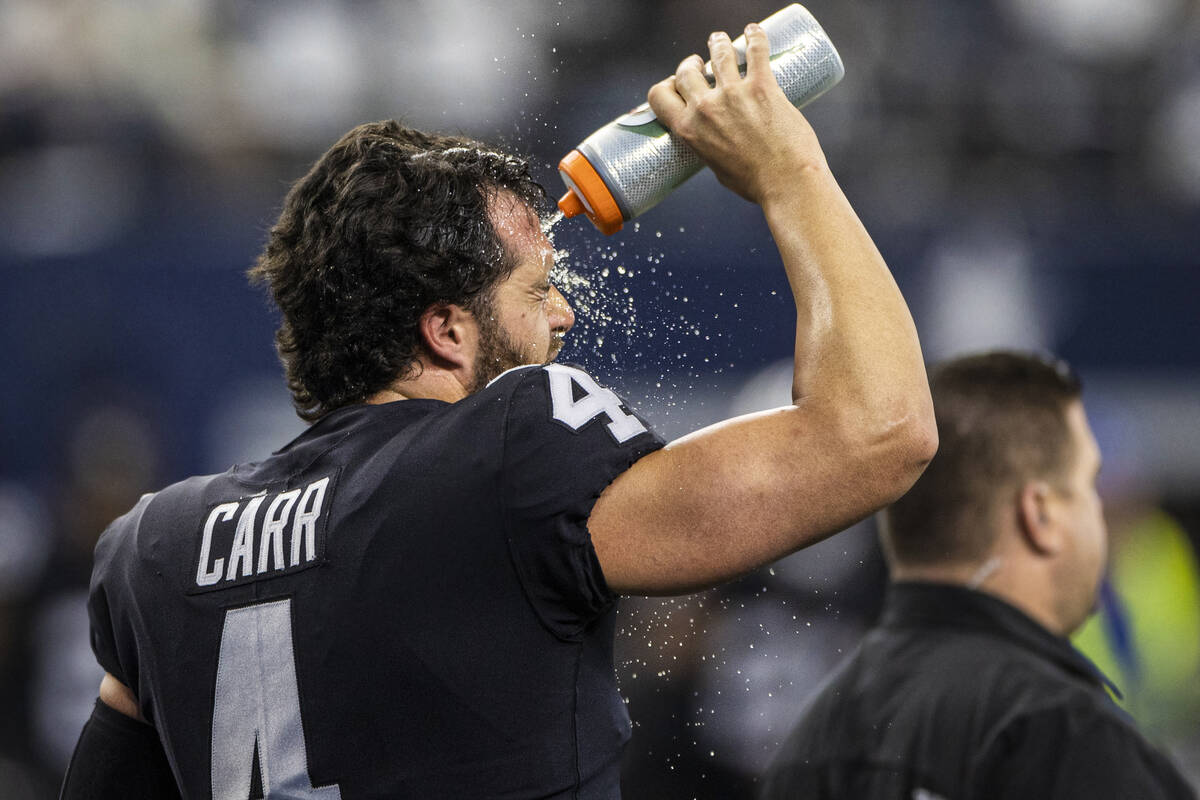 Raiders quarterback Derek Carr (4) cools off during warm ups before the start of an NFL footbal ...