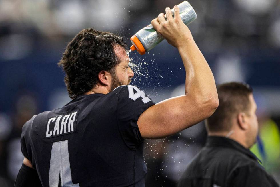 Raiders quarterback Derek Carr (4) cools off during warm ups before the start of an NFL footbal ...