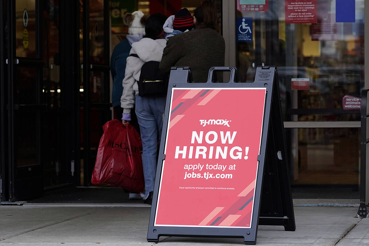 Hiring sign is displayed outside of a retail store in Vernon Hills, Ill., Saturday, Nov. 13, 20 ...