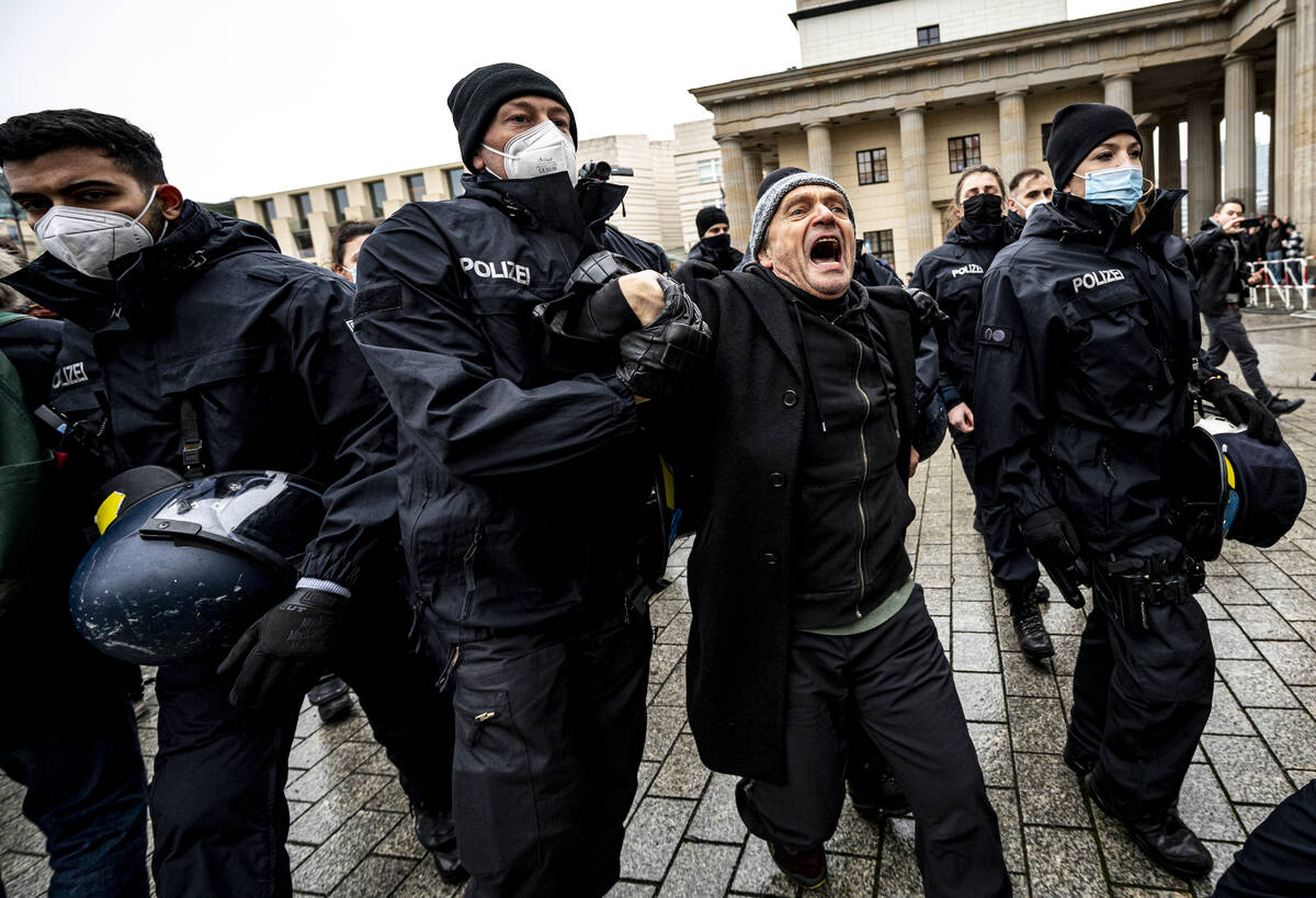The Berlin police takes away a participant of the forbidden demonstration of opponents of Coron ...