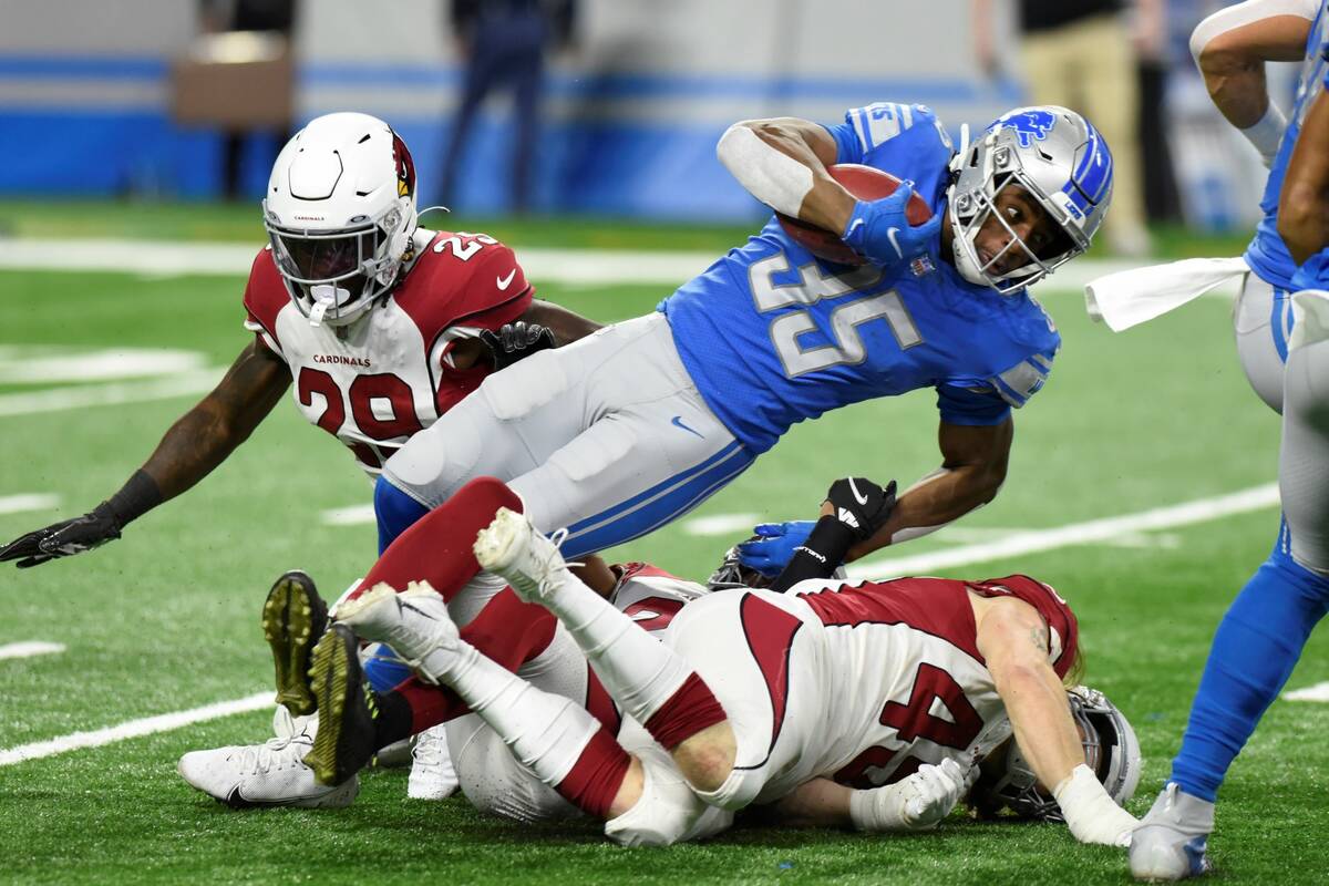 Detroit Lions running back Godwin Igwebuike (35) is tackled during the first half of an NFL foo ...