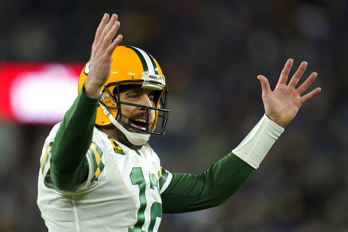 Green Bay Packers quarterback Aaron Rodgers celebrates running back Aaron Jones' touchdown in t ...