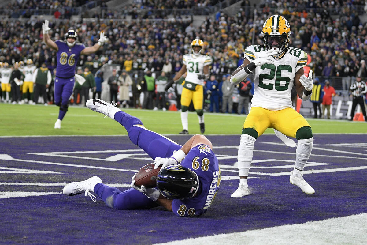 Baltimore Ravens tight end Mark Andrews scores a touchdown in front of Green Bay Packers free s ...