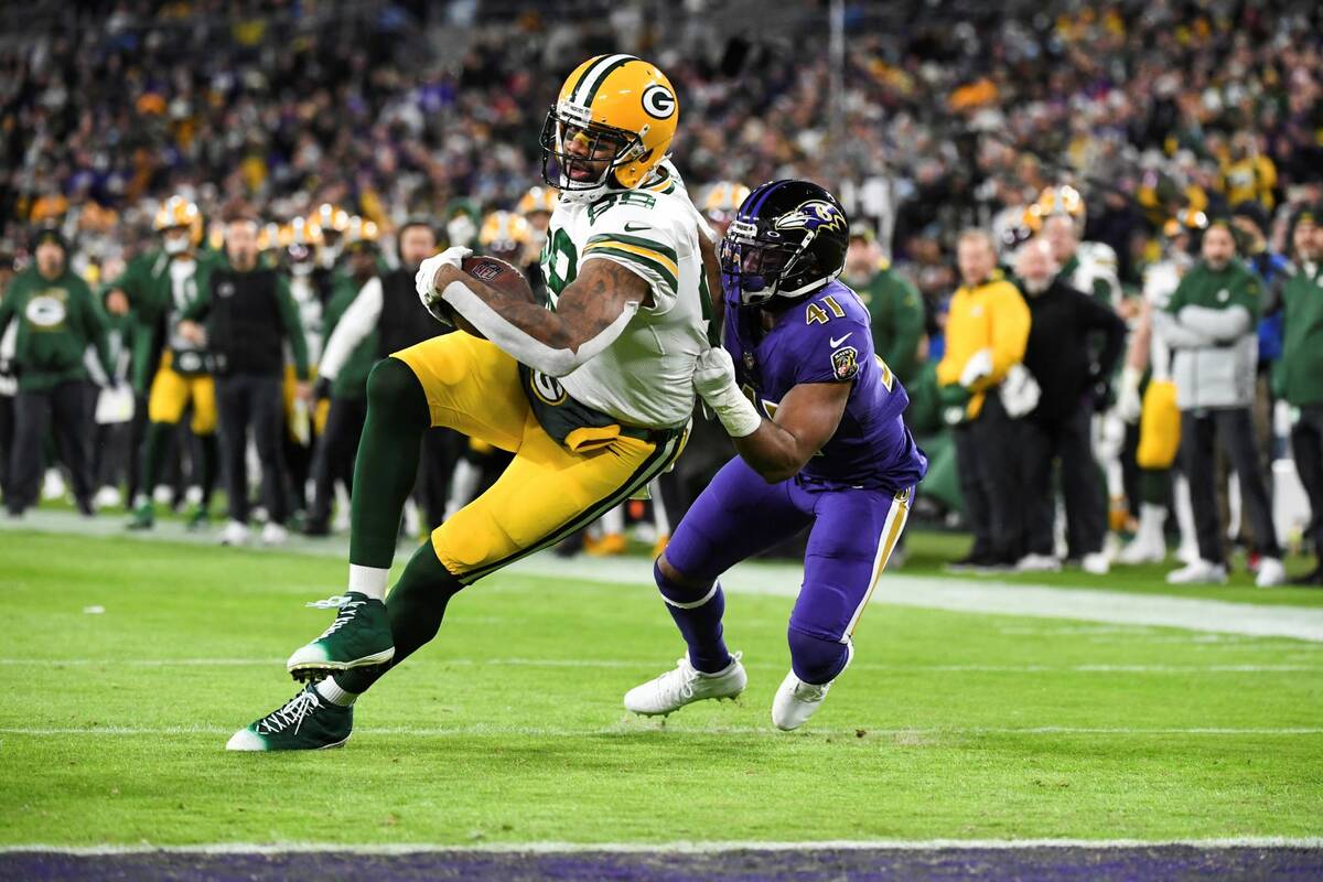 Green Bay Packers tight end Marcedes Lewis (89) is tackled by Baltimore Ravens defensive back A ...