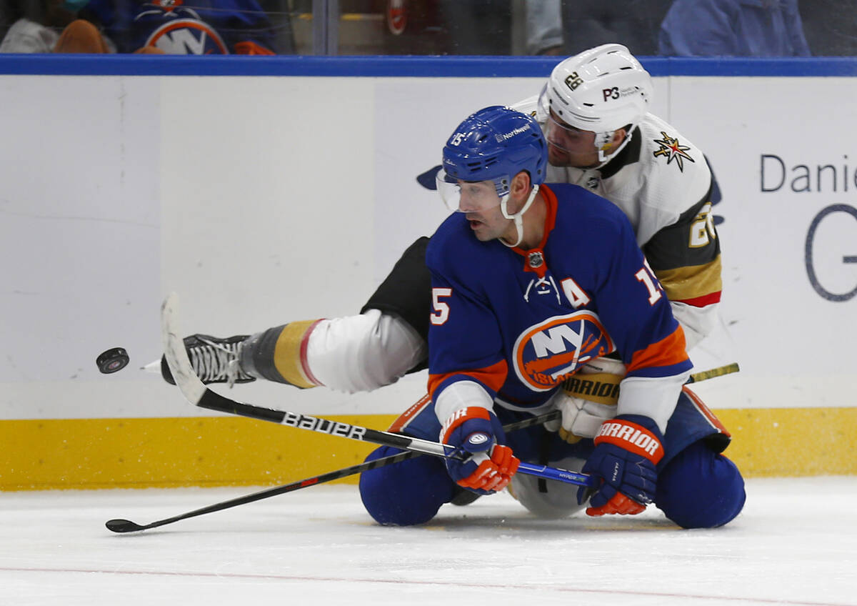 New York Islanders' Cal Clutterbuck (15) and Vegas Golden Knights' William Carrier (28) battle ...