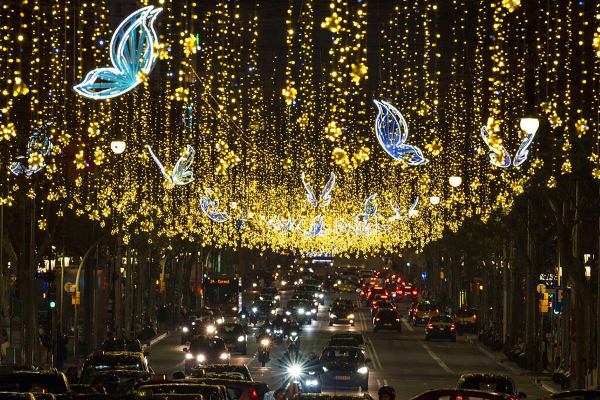 Christmas decorations illuminate one of the main avenues in Barcelona, Spain, Tuesday, Dec. 14, ...